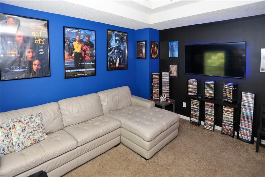 5854 El Segundo Way Atlanta, GA 30349 - Photo 15 of 63 a living room with furniture and a flat screen tv