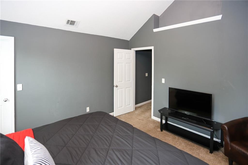 5854 El Segundo Way Atlanta, GA 30349 - Photo 19 of 63 a bedroom with a bed and flat screen tv
