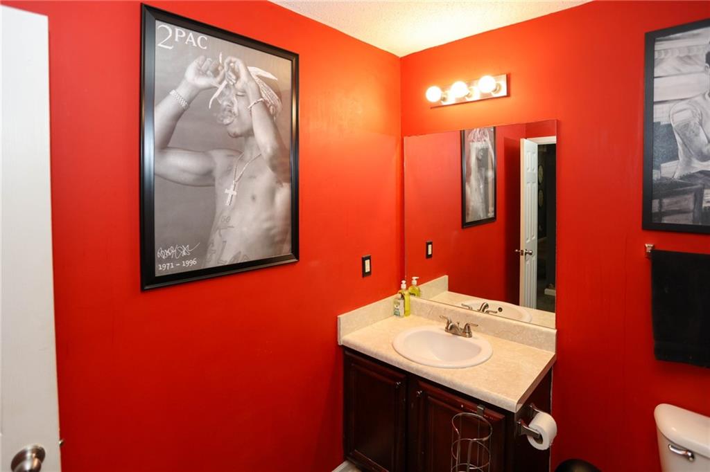 5854 El Segundo Way Atlanta, GA 30349 - Photo 22 of 63 a bathroom with a sink vanity and a mirror
