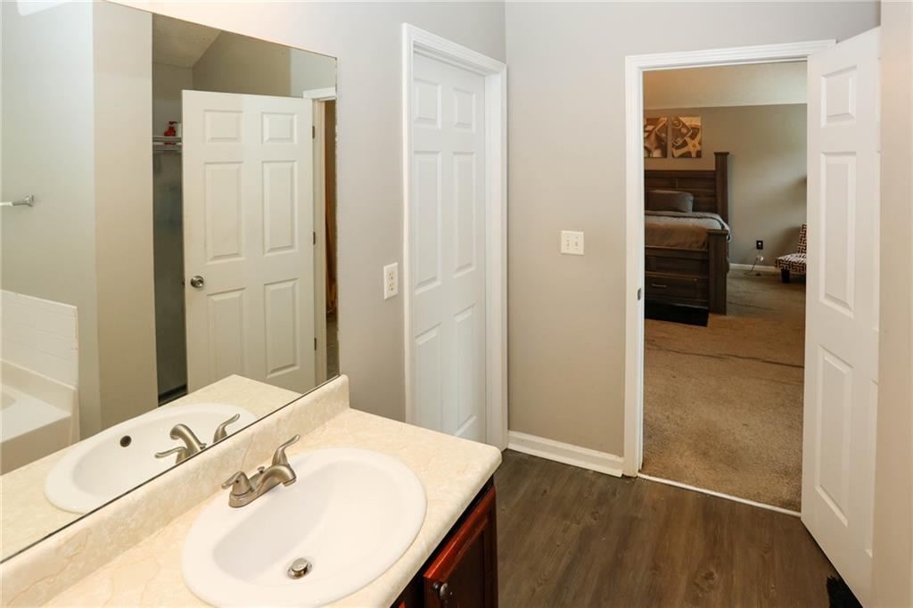 5854 El Segundo Way Atlanta, GA 30349 - Photo 27 of 63 a en suite bathroom with a sink and mirror