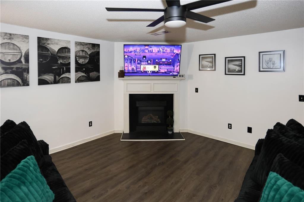 5854 El Segundo Way Atlanta, GA 30349 - Photo 38 of 63 a living room with furniture and a fireplace