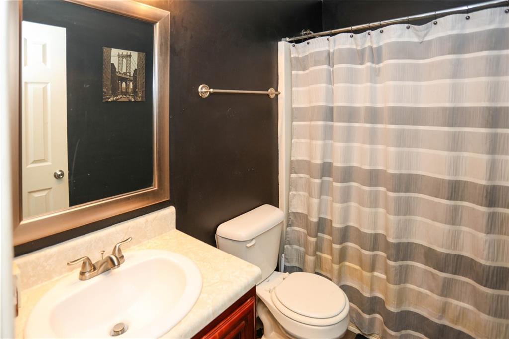 5854 El Segundo Way Atlanta, GA 30349 - Photo 42 of 63 a white toilet sitting next to a bathroom sink