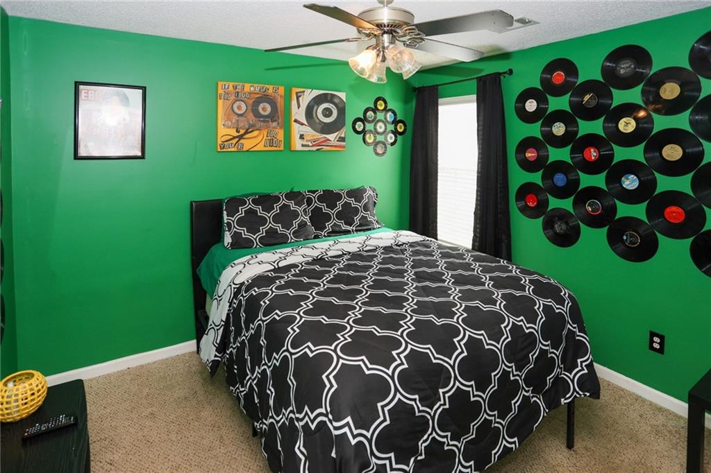 5854 El Segundo Way Atlanta, GA 30349 - Photo 44 of 63 a bed sitting in a bedroom next to a window with garden view