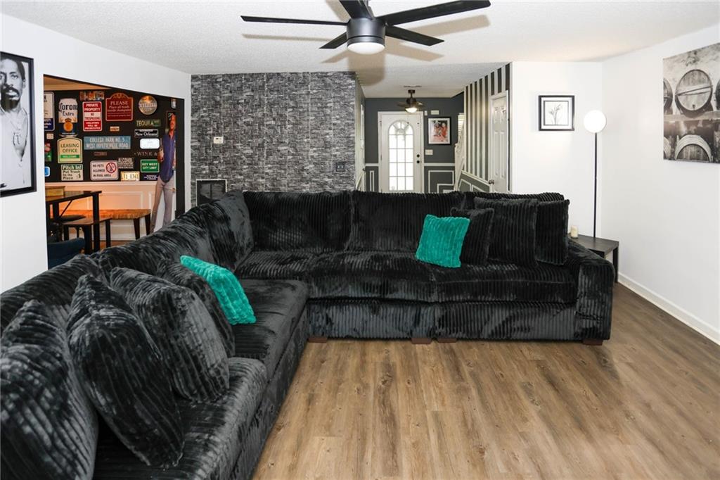 5854 El Segundo Way Atlanta, GA 30349 - Photo 47 of 63 a living room with furniture and wooden floor