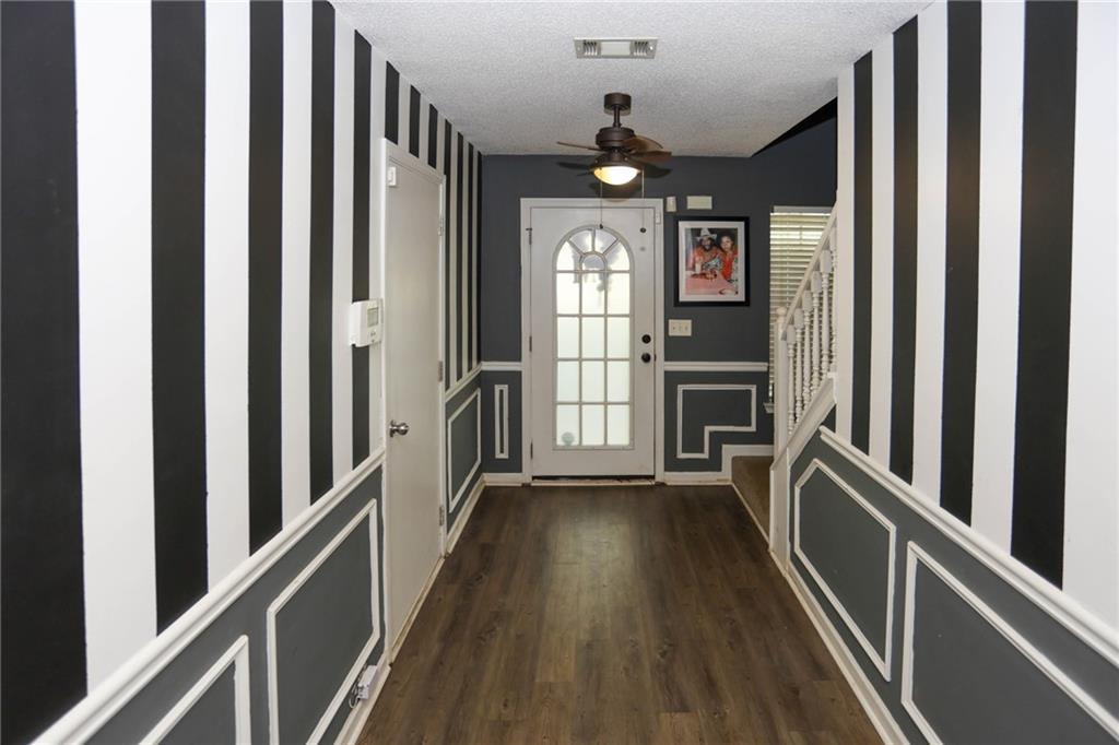 5854 El Segundo Way Atlanta, GA 30349 - Photo 53 of 63 a view of a hallway with wooden floor and staircase