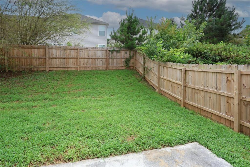5854 El Segundo Way Atlanta, GA 30349 - Photo 57 of 63 a view of a backyard with a wooden fence