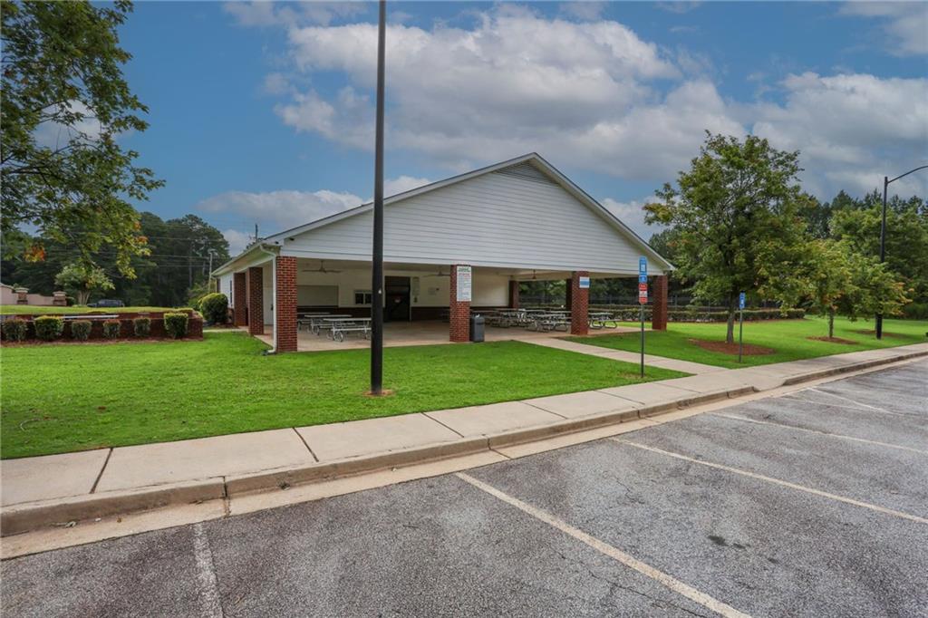 5854 El Segundo Way Atlanta, GA 30349 - Photo 60 of 63 a view of a house with a big yard plants and palm trees