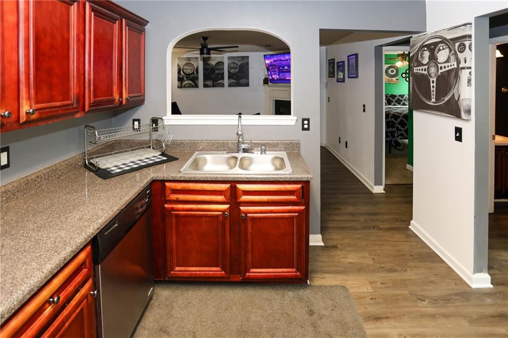 5854 El Segundo Way Atlanta, GA 30349 - Photo 9 of 63 a kitchen with stainless steel appliances granite countertop a sink and cabinets