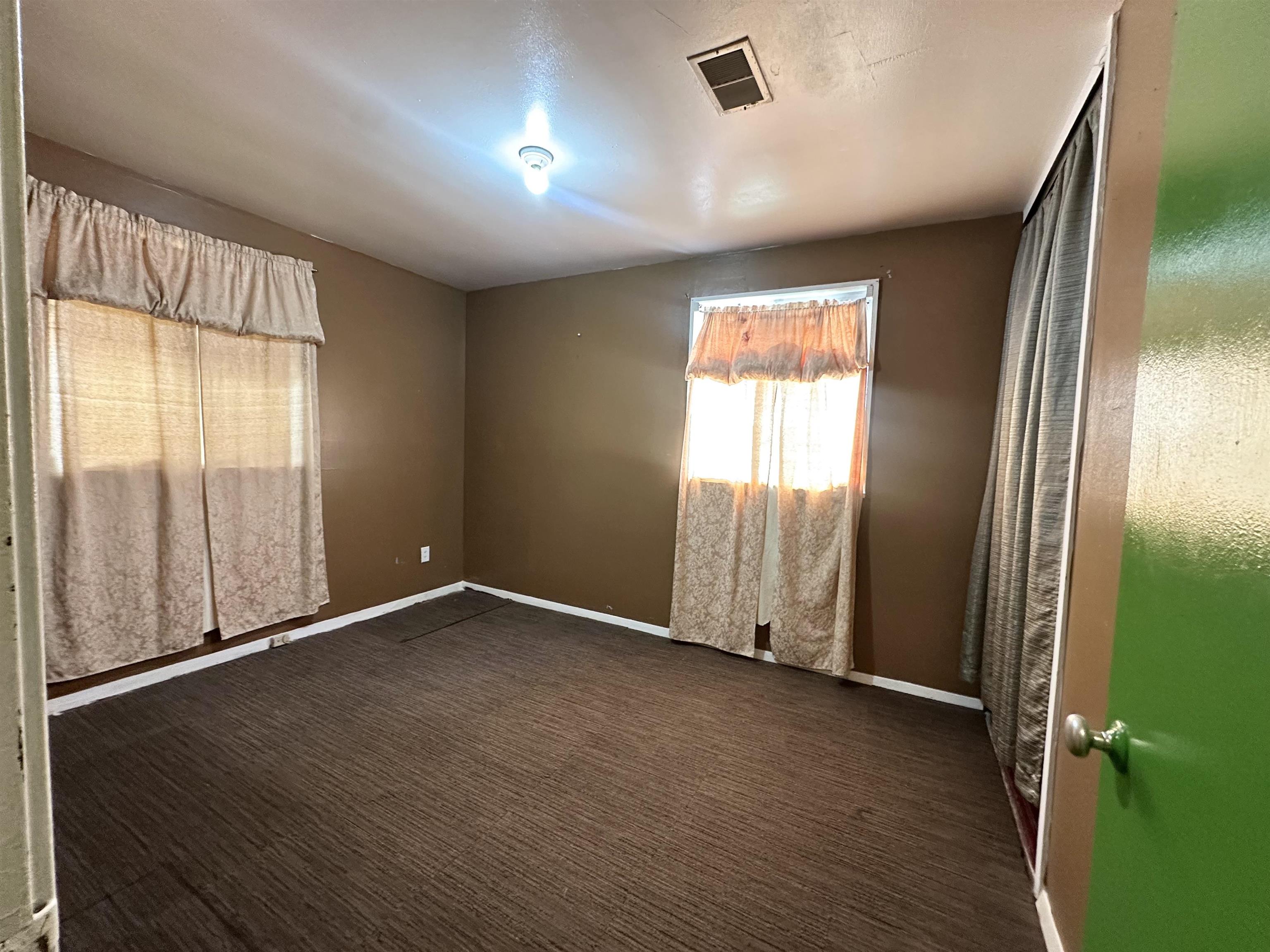 511 Jenson Road Memphis, TN 38109 - Photo 11 of 12 an empty room with wooden floor and windows