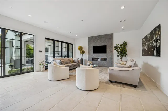 a living room with fireplace furniture and a flat screen tv