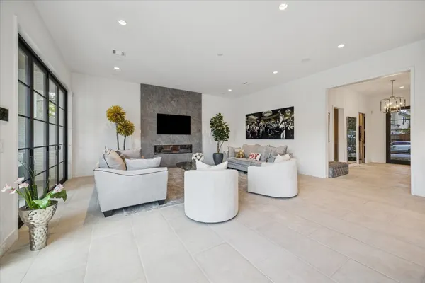 a spacious bathroom with a double vanity sink large mirror and a bathtub