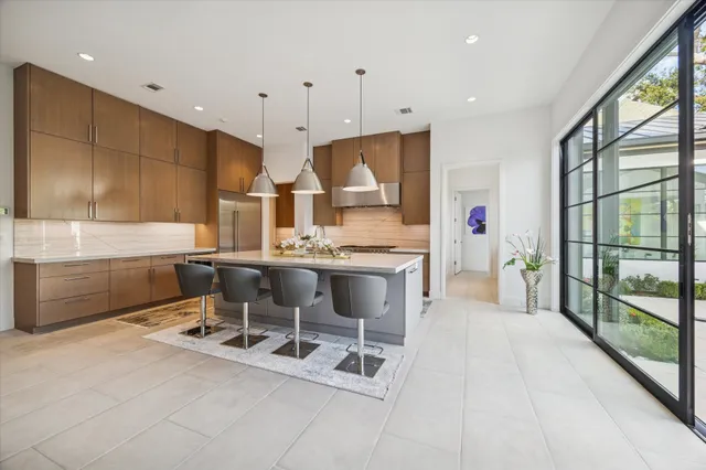 a kitchen with stainless steel appliances kitchen island granite countertop a sink and cabinets