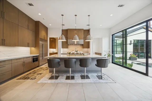 a large kitchen with a table and chairs