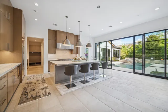 a kitchen with stainless steel appliances kitchen island granite countertop a sink and cabinets