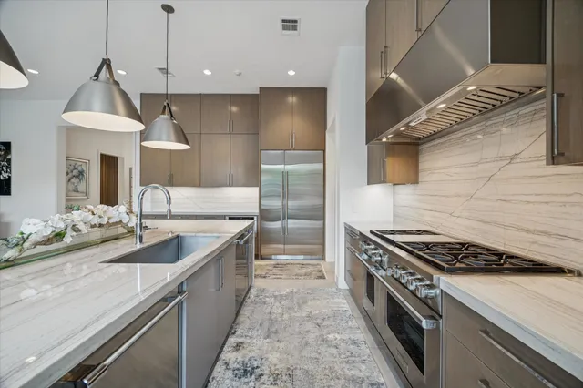 a kitchen with granite countertop a sink and a stove