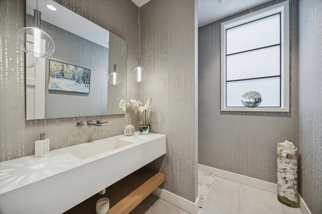 a bathroom with a sink a mirror and a window