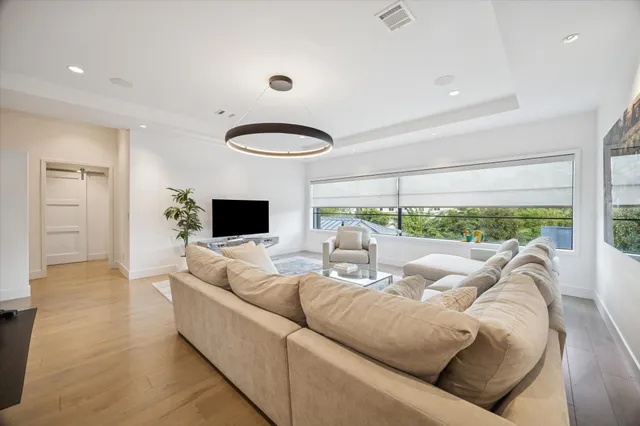 a living room with furniture fireplace and a large window