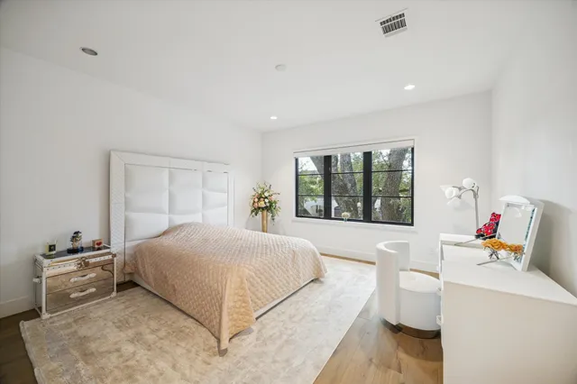 a bedroom with a large bed and a window