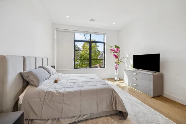 a bedroom with a bed and a flat screen tv