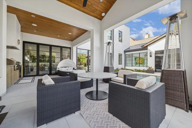 a living room with couches a coffee table and a large window with garden view