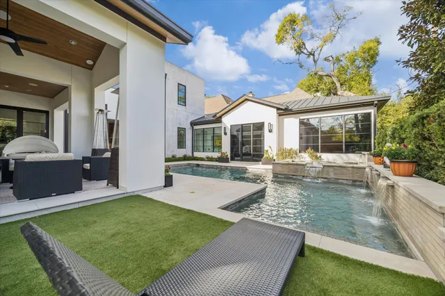 a view of a house with pool and a yard