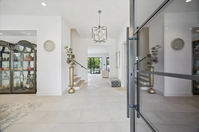 a view of a hallway with windows and entryway