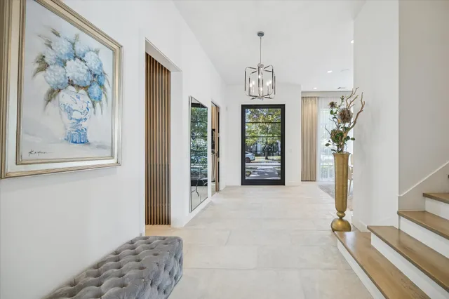 wooden floor with a chandelier in a room