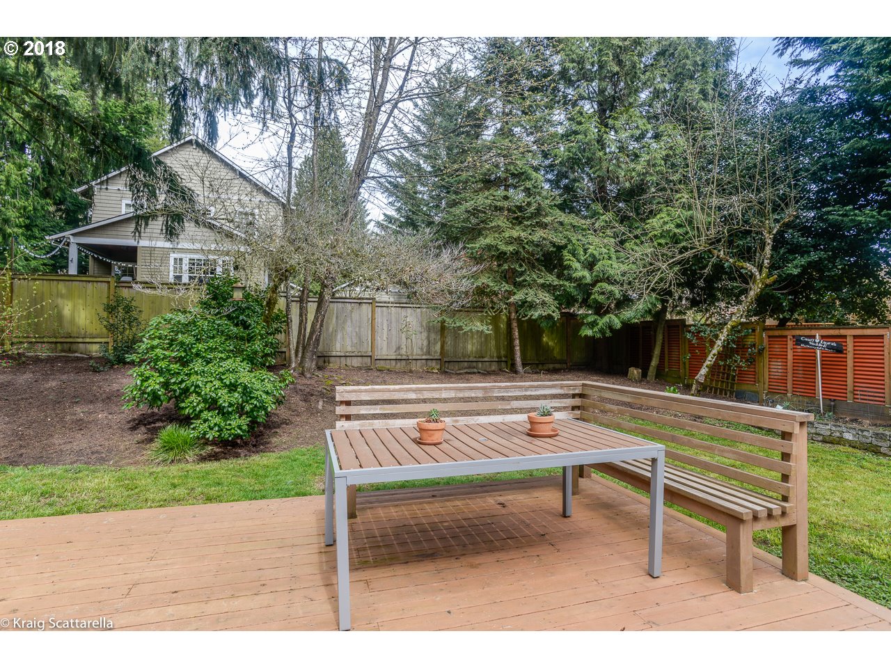 9 Southwest Collins Street Portland, OR 97219 - Photo 23 of 26 a backyard of a house with table and chairs