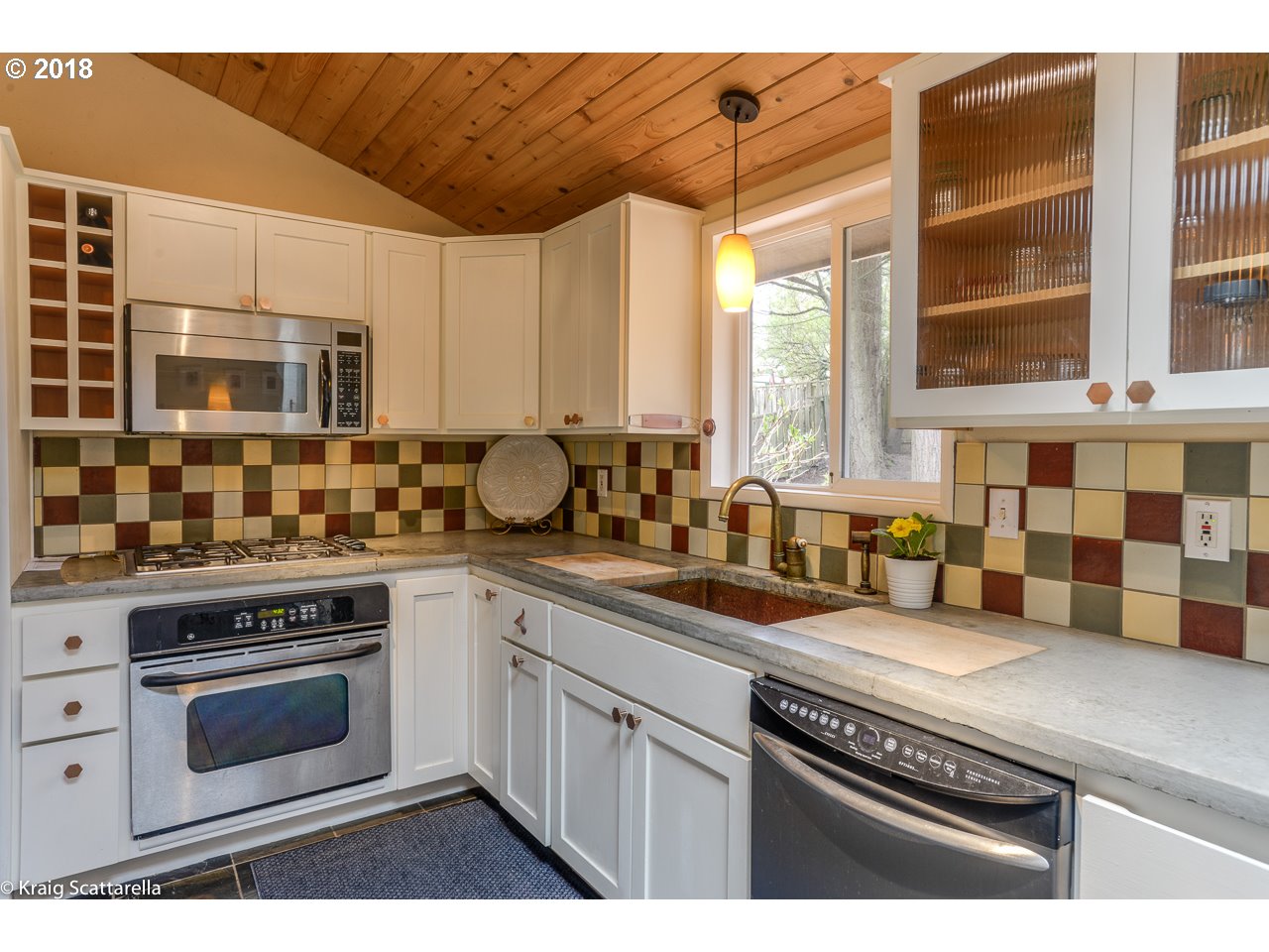 9 Southwest Collins Street Portland, OR 97219 - Photo 10 of 26 a kitchen with stainless steel appliances a stove a sink and a microwave