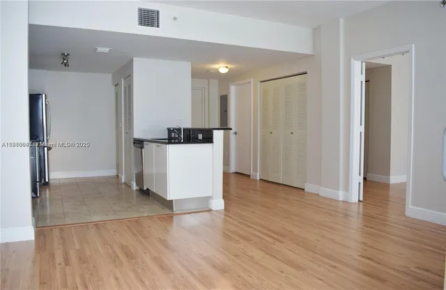 a view of a kitchen with wooden floor