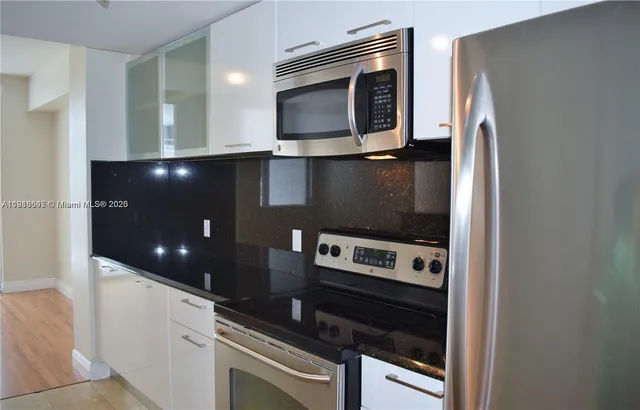 a kitchen with a stove and a microwave