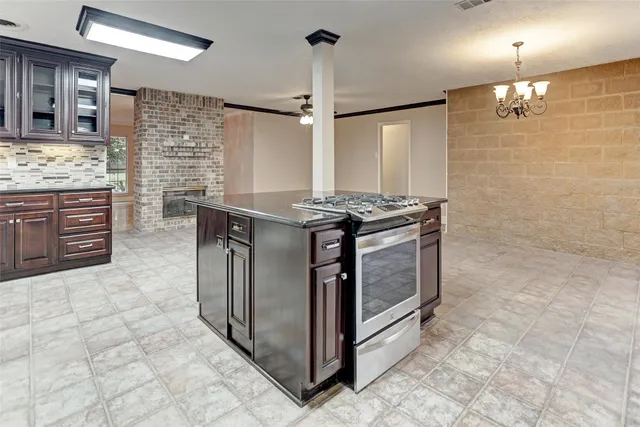 a kitchen with stainless steel appliances granite countertop a stove and a sink