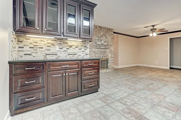 a view of kitchen with granite countertop cabinets and outdoor space