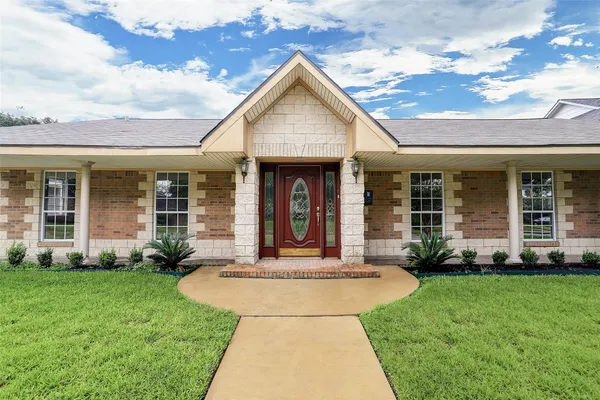 a front view of a house with garden