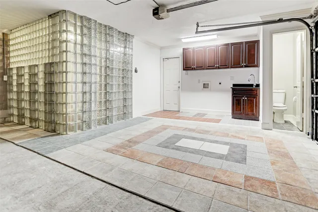 a bathroom with a granite countertop sink a toilet a mirror and bathtub