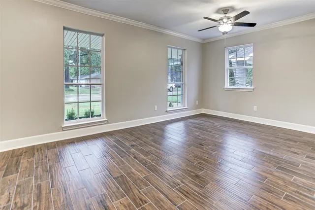 a bathroom with a granite countertop sink a toilet and a mirror