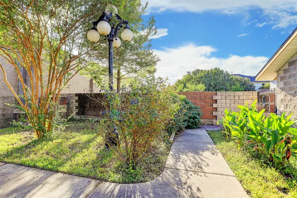 a view of a house with backyard and a tree