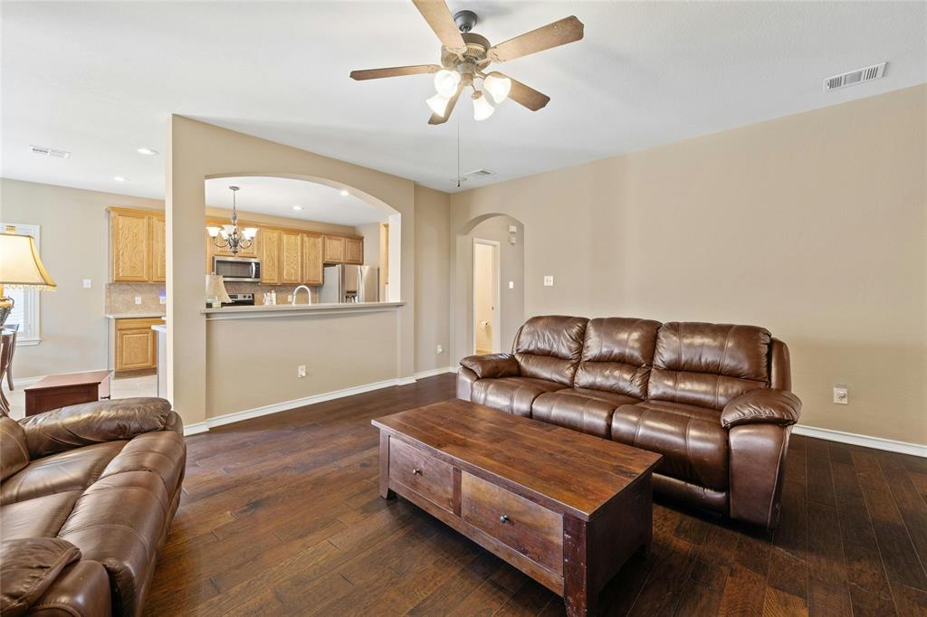 2603 White Stallion Way Leander, TX 78641 - Photo 13 of 40 Living area with dark wood-style flooring, a chandelier, recessed lighting, arched walkways, and ceiling fan