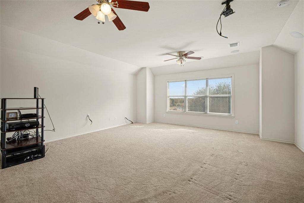 2603 White Stallion Way Leander, TX 78641 - Photo 30 of 40 Unfurnished living room with carpet flooring, vaulted ceiling, and ceiling fan