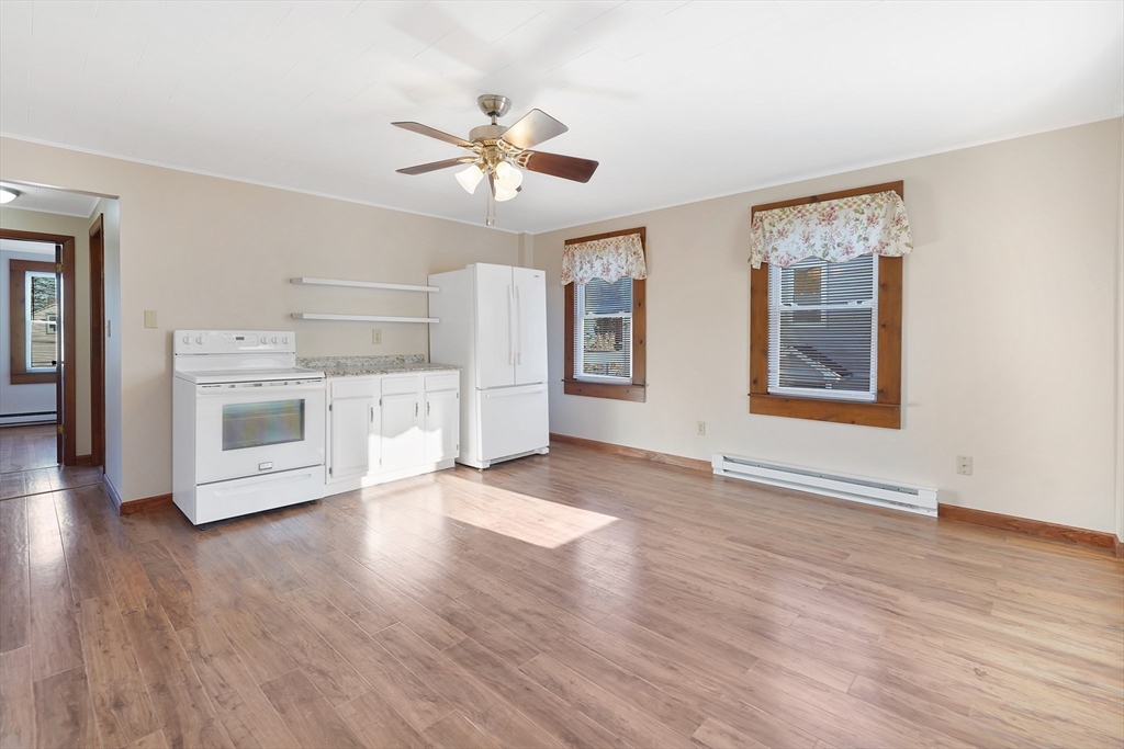2022 Maple Street Three Rivers, MA 01080 - Photo 31 of 42 a view of a kitchen with a dishwasher cabinets and wooden floor