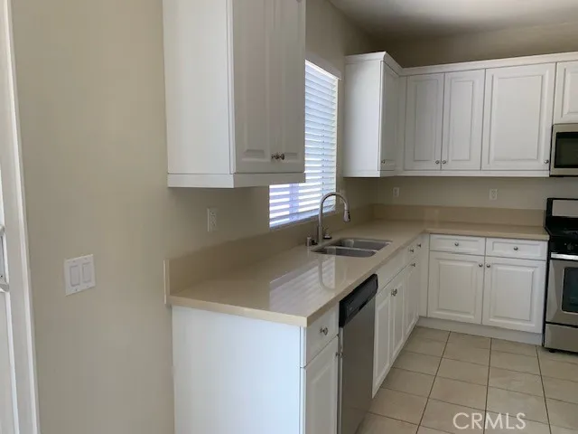 a kitchen with a sink cabinets and window