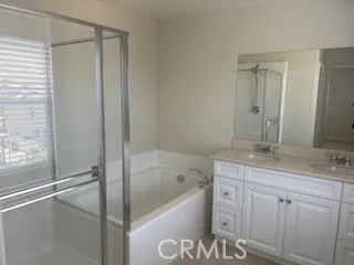 a bathroom with a granite countertop sink a toilet and bathtub