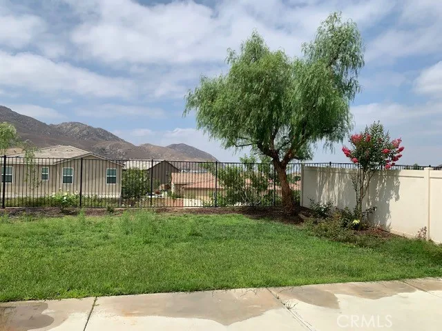 a front view of a house with a yard and trees