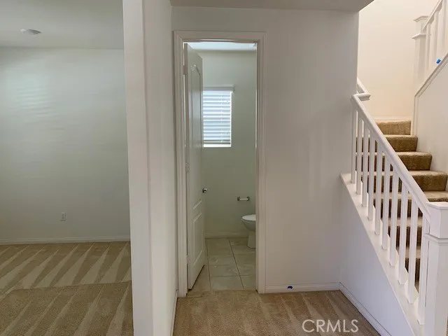 a view of a hallway with wooden floor and entryway