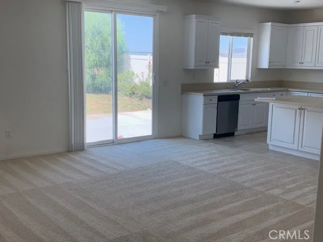 a view of a kitchen and microwave