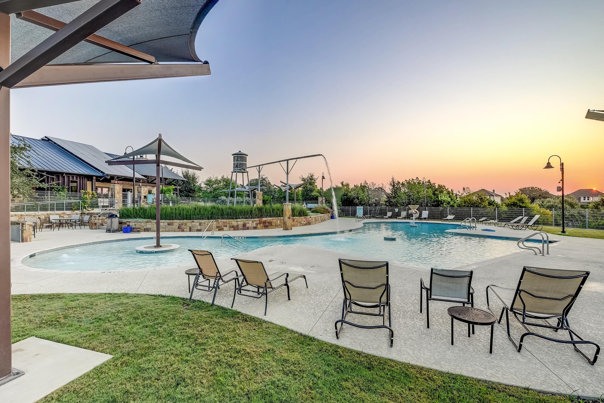 68 Rancho Trail Georgetown, TX 78628 - Photo 28 of 39 An inviting community pool with various water features awaits, offering relaxation under the wide open sky.