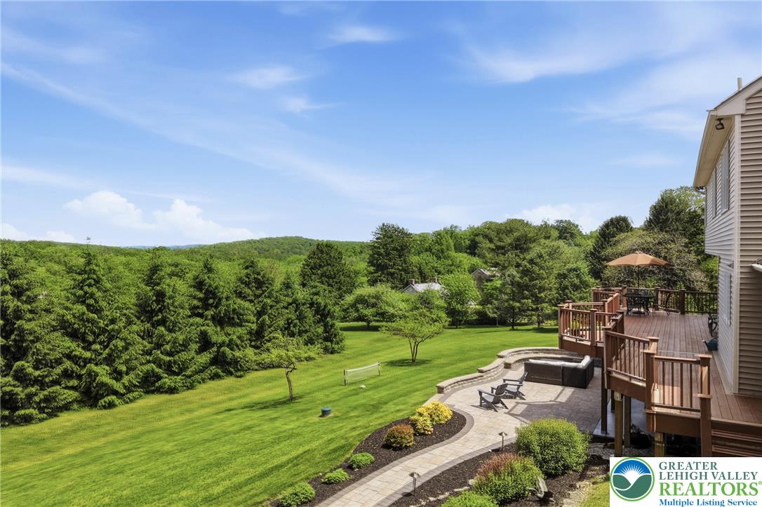 115 West Butternut Road Hellertown, PA 18055 - Photo 65 of 97 An inviting multi-level deck and patio overlook the sprawling green lawn and distant tree-lined hills.