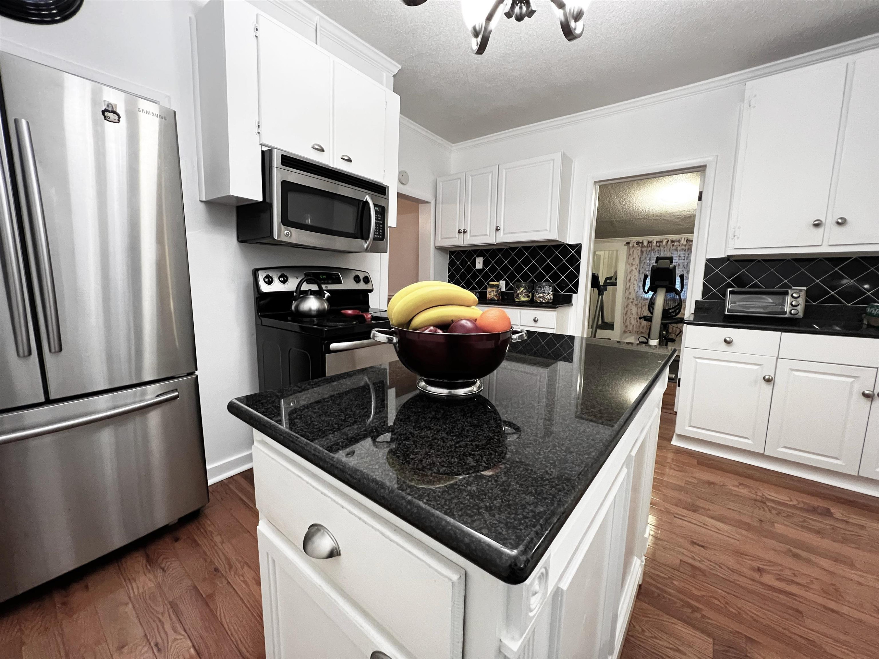 424 Eugene Street Durham, NC 27701 - Photo 11 of 26 a kitchen with stainless steel appliances granite countertop a sink a stove and a refrigerator