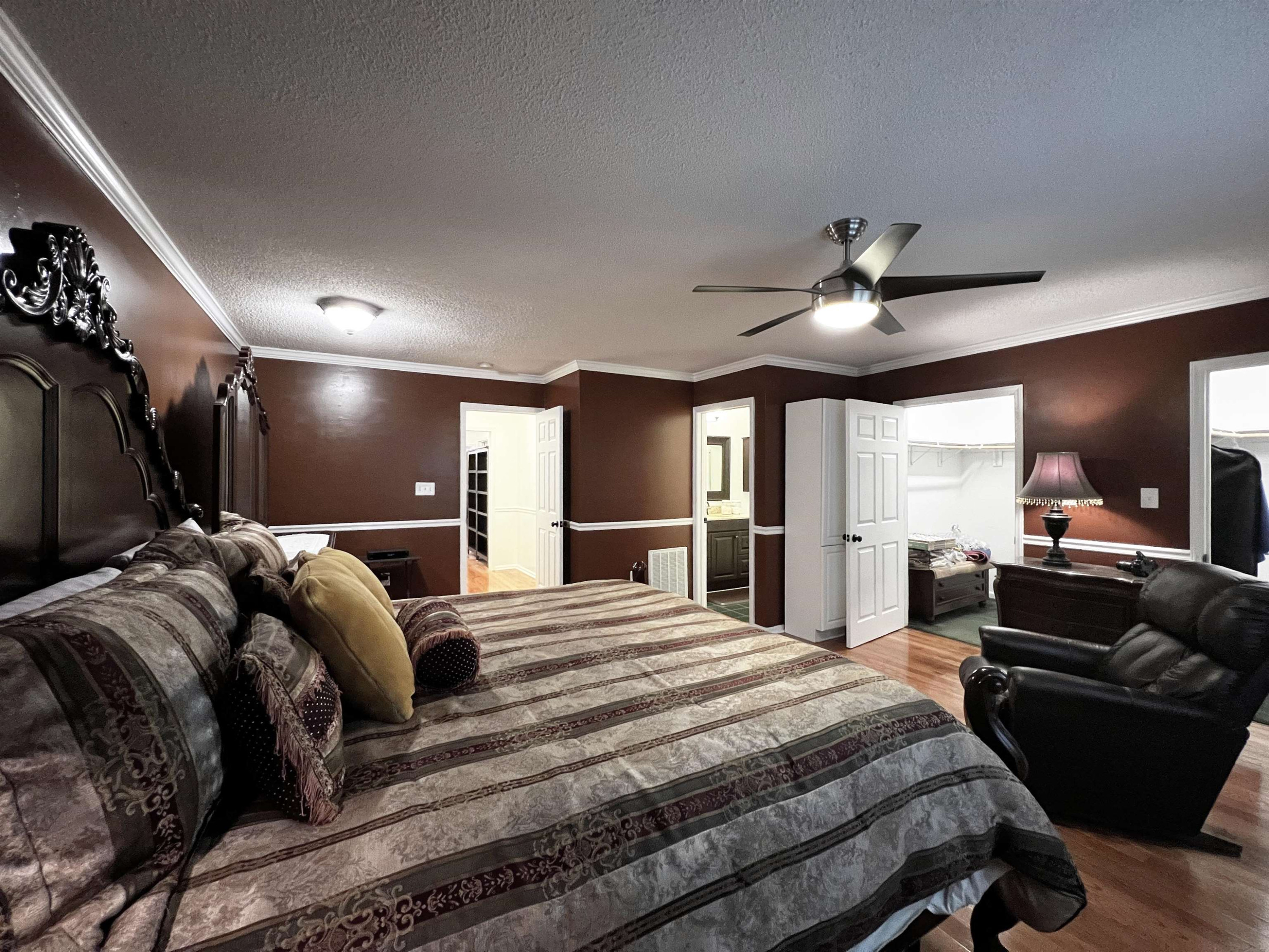 424 Eugene Street Durham, NC 27701 - Photo 14 of 26 a large bedroom with a bed and ceiling fan