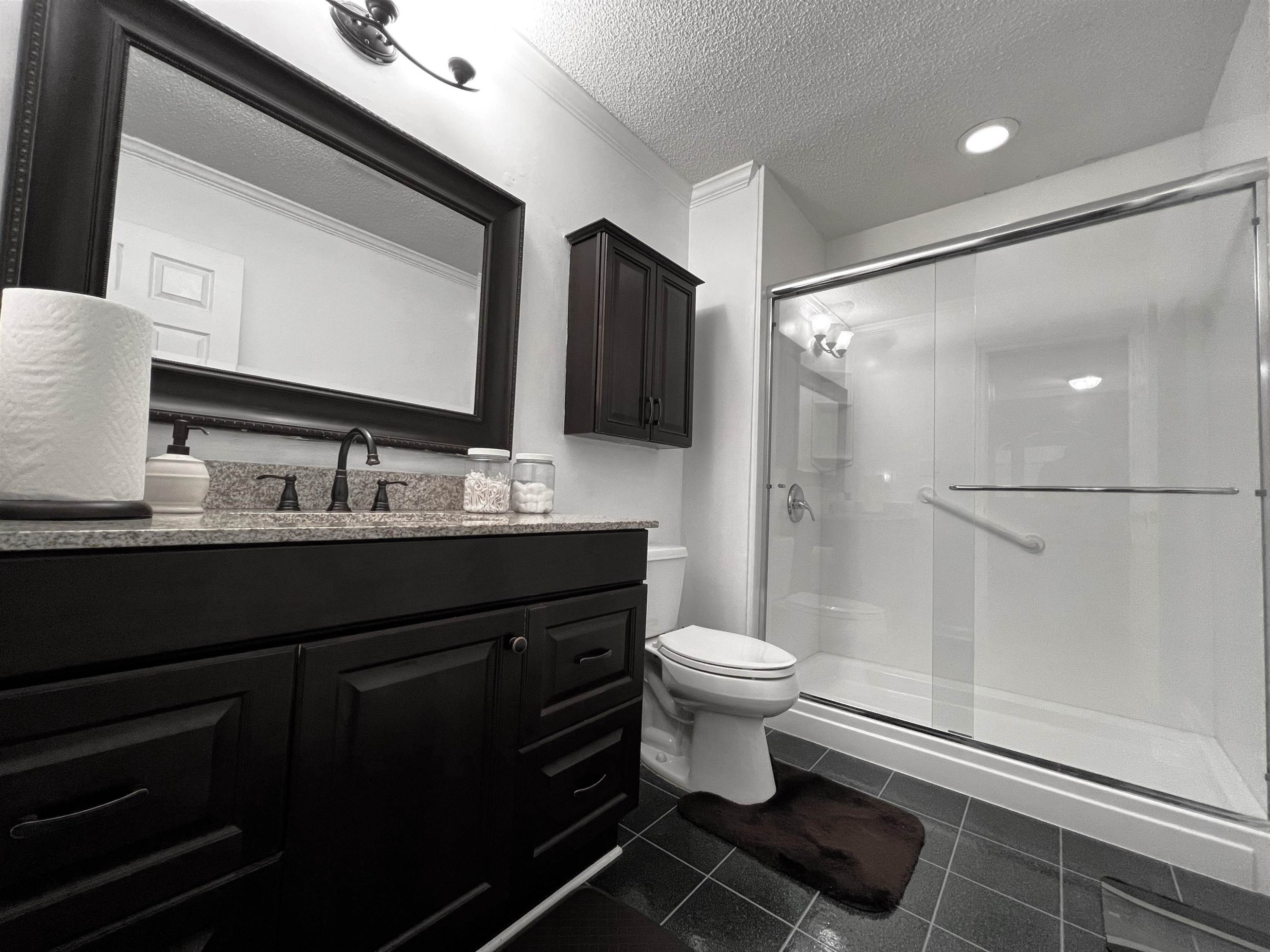 424 Eugene Street Durham, NC 27701 - Photo 16 of 26 a bathroom with a sink toilet a mirror and shower